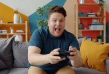 Man playing video games with excited expression