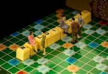 3 men in gray suit standing beside yellow lego blocks