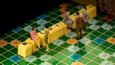 3 men in gray suit standing beside yellow lego blocks