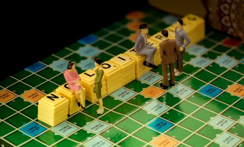 3 men in gray suit standing beside yellow lego blocks