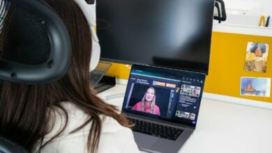 a woman sitting in front of a laptop computer