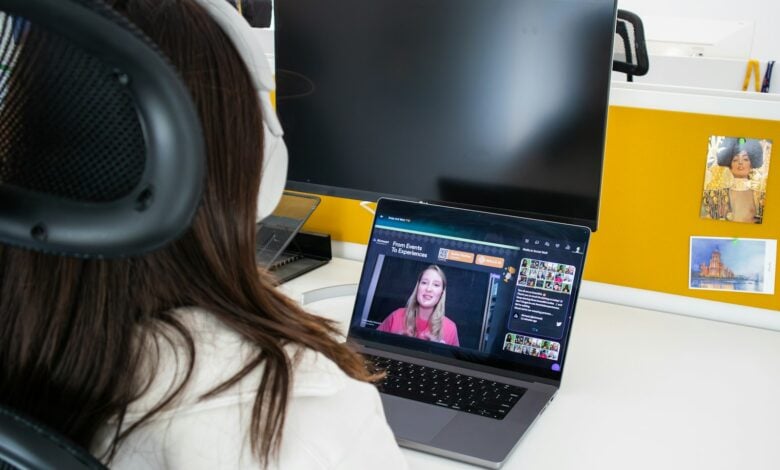 a woman sitting in front of a laptop computer