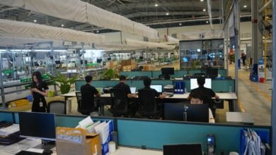 People working at computers in a modern office space.