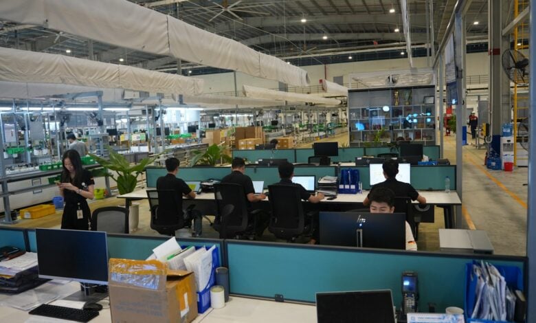 People working at computers in a modern office space.