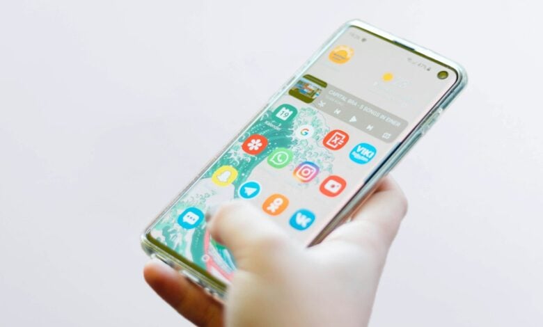 person using silver Android smartphone